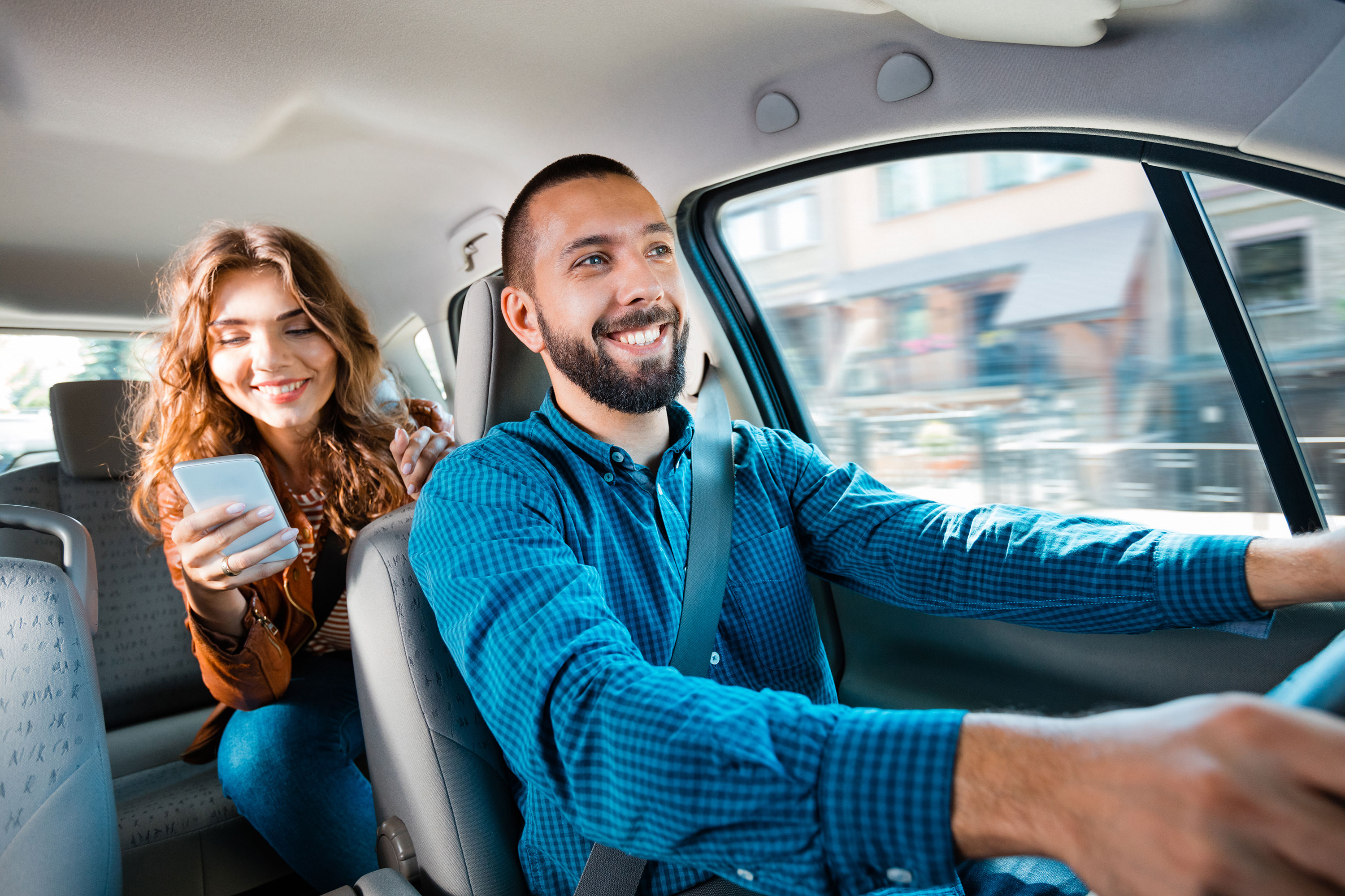Smiling Driver Talking With Female Passenger